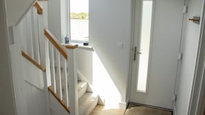 A staircase with wooden handrails leading to a landing. - Clemens Beach House, Sea Views, Private Lane, Crantock, Sleeps 4. (Crantock, Cornwall)