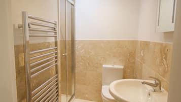 Shower, hair dryer, towels, toilet paper