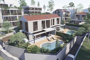 A modern residential building with a rooftop pool and outdoor seating area.