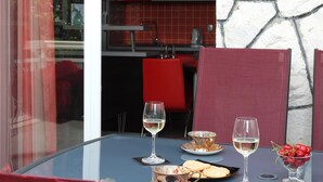 A dining table with wine glasses, a plate of cookies, and a bowl of cherries. - Authentic Dalmatian Getaway • Pool & free parking (Trogir)