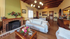 A living room with a fireplace, sofa, and coffee table. - Vill Pergola Elli, holiday apartment in Corfu, Greece with stunning sea view! (Corfu)