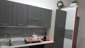 A modern kitchen with grey cabinets, a stainless steel sink, and a built-in oven. - HOLIDAY HOME Central Station, Business Center, Naples city center, Mary's Room (Napoli)