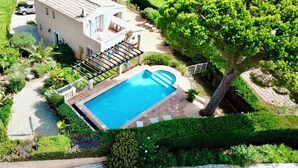A large house with a swimming pool, surrounded by lush greenery and trees. - Gorgeous sea view, heated pool, jacuzzi, sauna, close to the beach. (Sainte-Maxime)