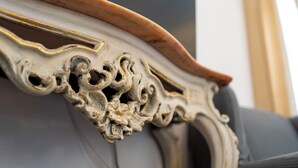 A close-up of an ornate, carved wooden chair backrest with intricate detailing. - Large apartment at Residece Ca of NI - Finalborgo (Finale Ligure)