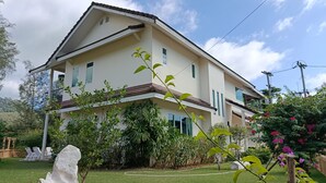 A two-story house with a balcony, surrounded by lush greenery and a well-maintained lawn. - Wonderful Villa with Private Pool, Best Location! Walk to beach, restaurants etc (Khao Lak)