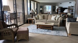 Un salón amplio con un sofá grande, una mesa de centro y un comedor con sillas.