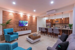 A modern living room with a TV, sofa, and coffee table.