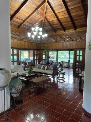 Relax in a spacious room with a comfortable sofa set near a window offering a view of the outdoors.