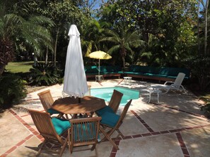 Relax by the serene pool surrounded by lush greenery and comfortable seating areas.