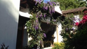 A traditional building with a white facade, a tiled roof, and a bell tower. - Charming Home, Beautiful Decorated in famous Central Antigua  (Antigua Guatemala)