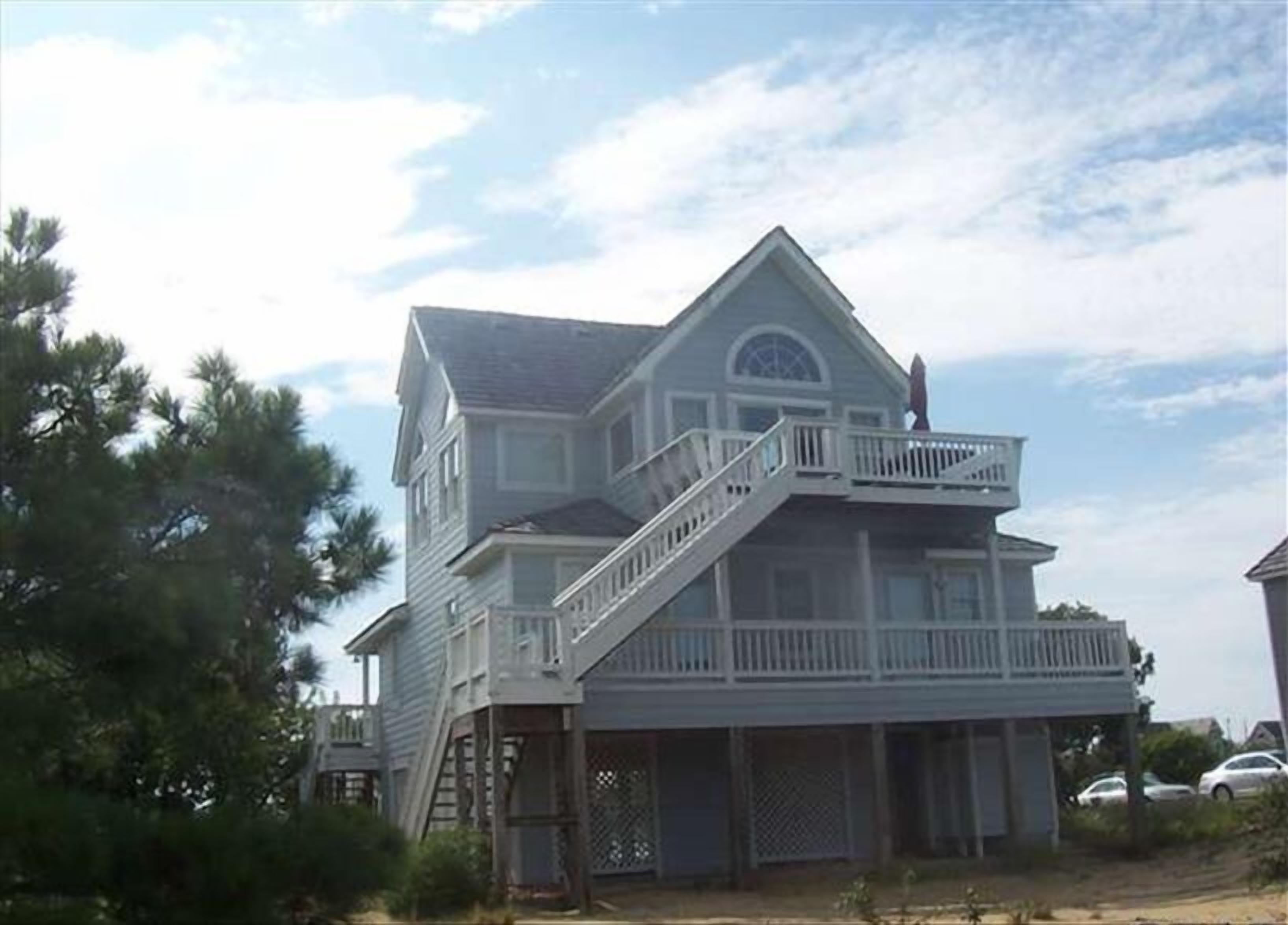 A two-story house with a balcony and a garage.