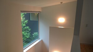 A modern room with a skylight, a small window, and a ceiling light fixture. - Wistaria Karuizawa (Karuizawa)