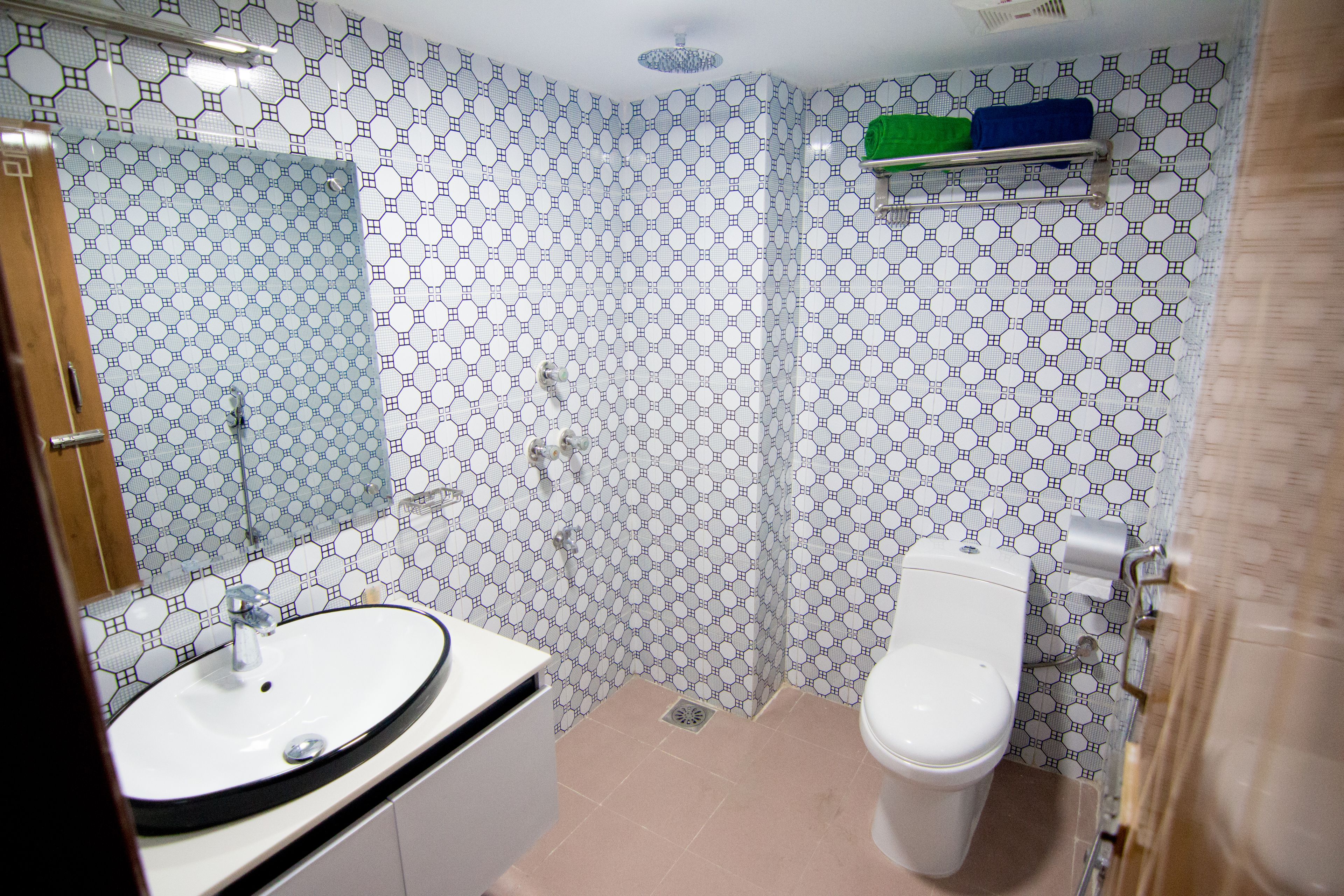 A bathroom with a sink, toilet, and shower area.