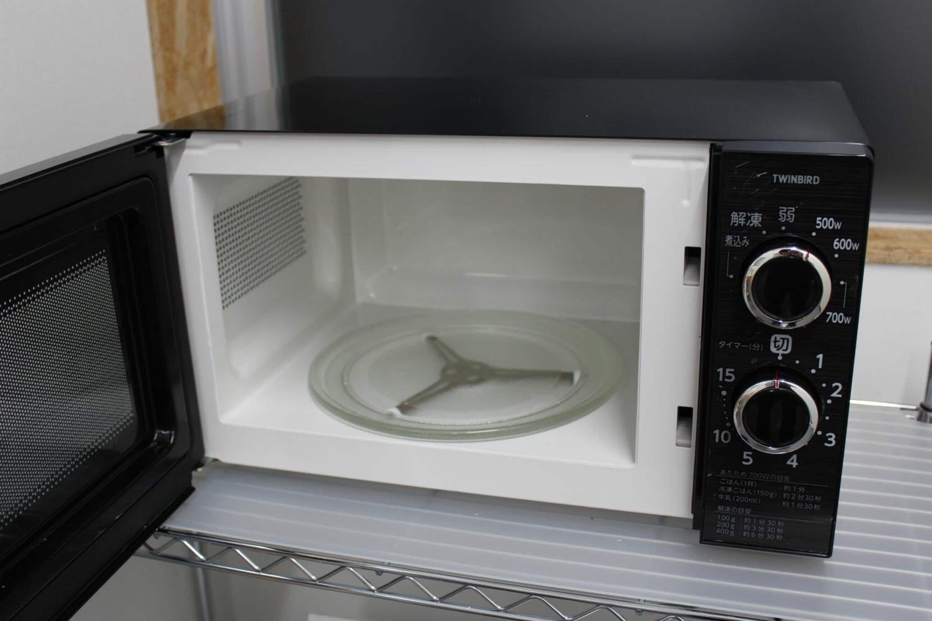 A microwave with a digital display and multiple power settings.