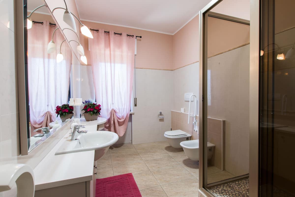 A bathroom with a sink, mirror, and toilet.