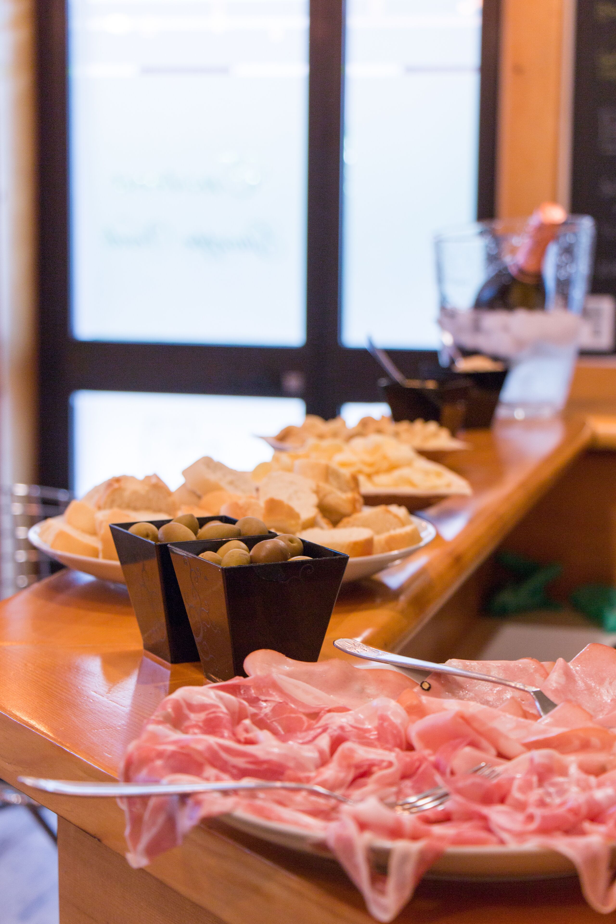 A buffet table with various food items and utensils.