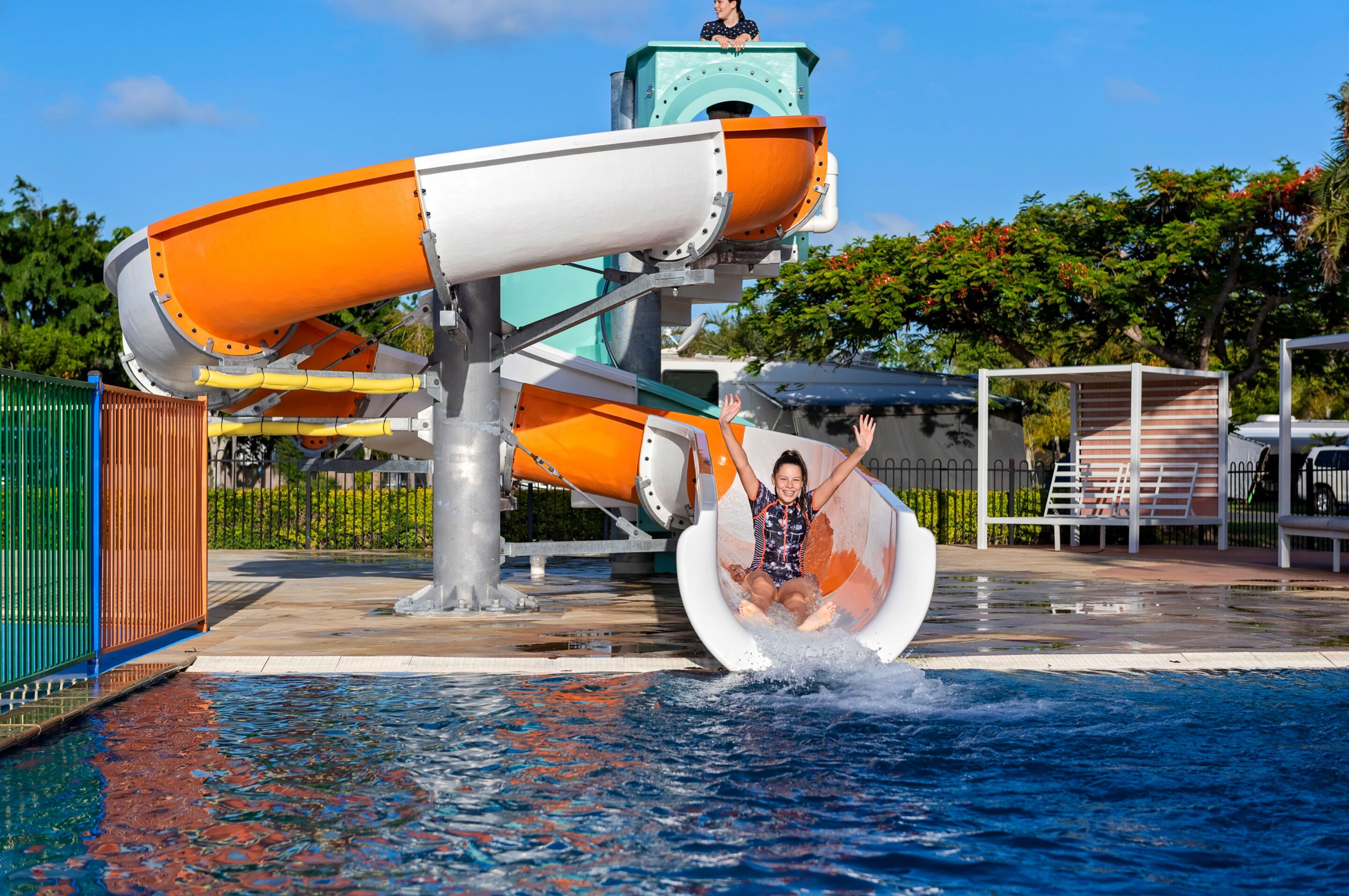 A water slide at a water park with a person sliding down.