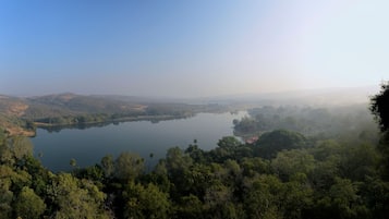 A lake surrounded by dense forest and hills.