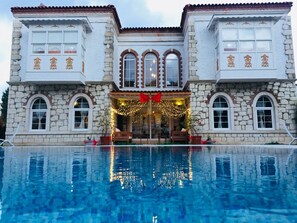 A large stone building with a swimming pool in front. - Kerme Ottoman Alacati (Cesme)