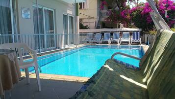 Seasonal outdoor pool, open 10:00 AM to 7:00 PM, pool umbrellas