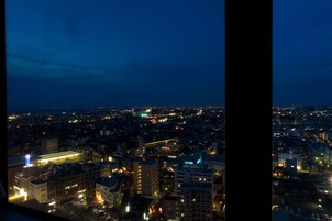 A nighttime cityscape with illuminated buildings and streets.