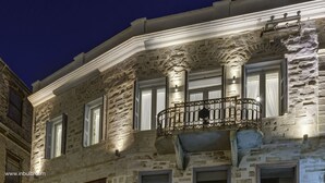 A stone building with a balcony, large windows, and a night sky. - 1844 Suites Syros (Syros)