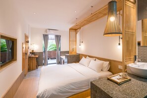 A modern hotel room with a large bed, a bathroom with a sink, and a view of the outdoors. - Zen Tea House Seven Stars Park (Guilin)