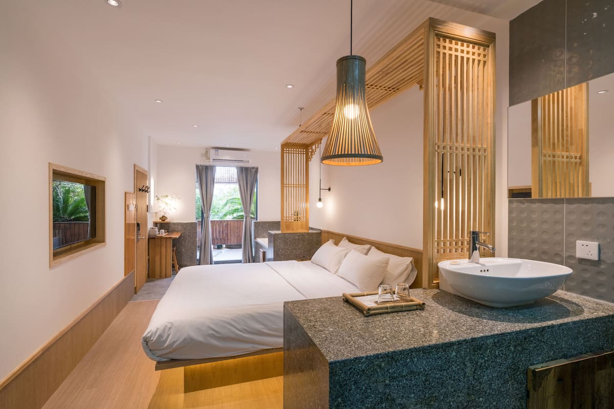 deluxe king room with garden view | premium bedding, pillow-top beds, in-room safe, blackout curtains