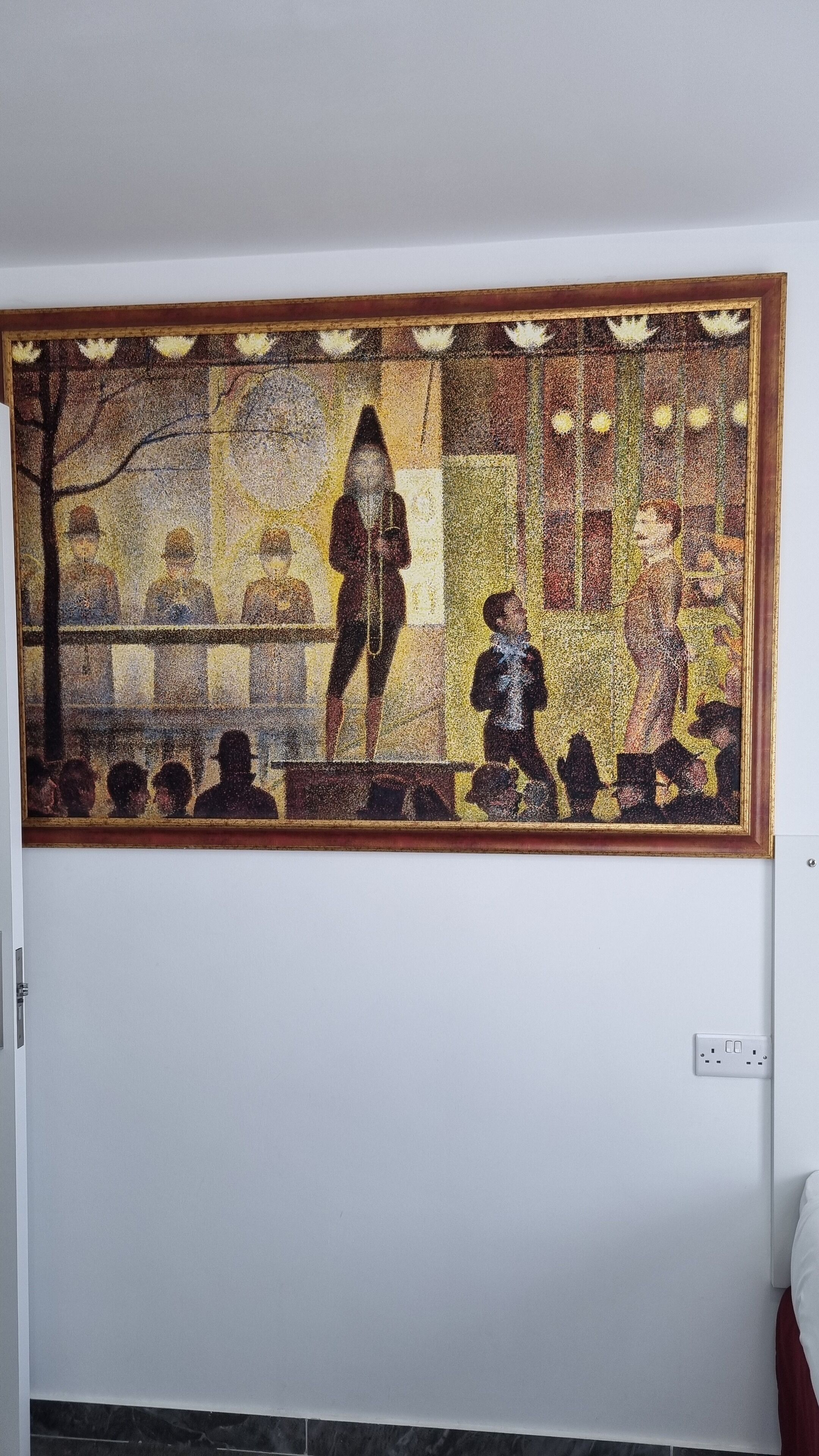 A large, rectangular mosaic artwork on a plain wall.
