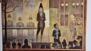 A large, rectangular mosaic artwork on a plain wall.