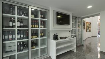 A modern interior with a wine cellar, a flat-screen TV, and a minimalist design.