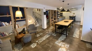 Un espacio habitable amplio con una mesa de comedor de madera, un sofá y una estantería.