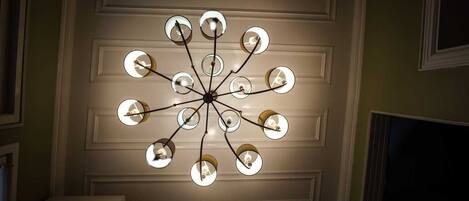 A ceiling with a modern chandelier design featuring multiple spherical light fixtures.