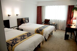 A hotel room with two beds, a desk, a chair, and a window with curtains. - Shanghai Coinfamily Hotel (Shanghai)