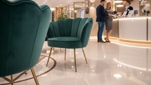A reception area with teal chairs, a reception desk, and a sign labeled 'RECEIVE'. - Lázeňský Hotel Pyramida I (Frantiskovy Lazne)