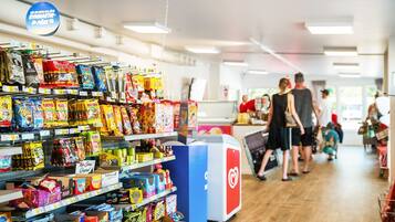 A grocery store aisle with various snacks and packaged goods.