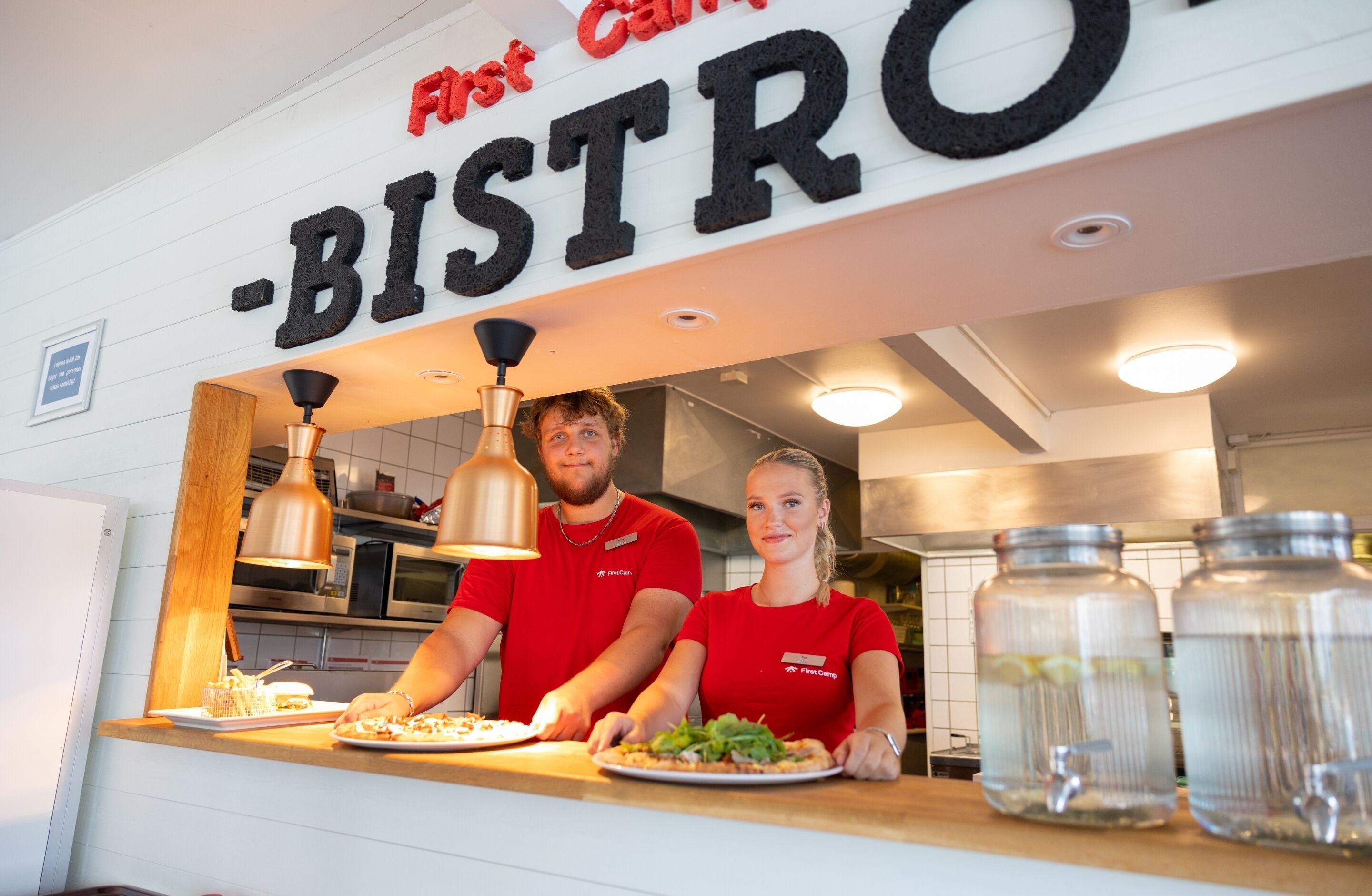 A restaurant counter with a sign reading "First Canteen - BISTRO".