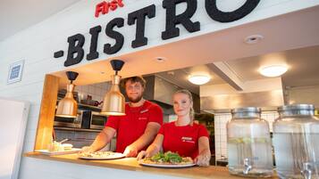 A restaurant counter with a sign reading "First Canteen - BISTRO".