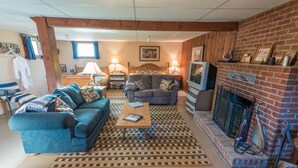 A cozy living room with a blue sofa, a wooden coffee table, and a fireplace. - Wilson Ranches Retreat (Fossil)
