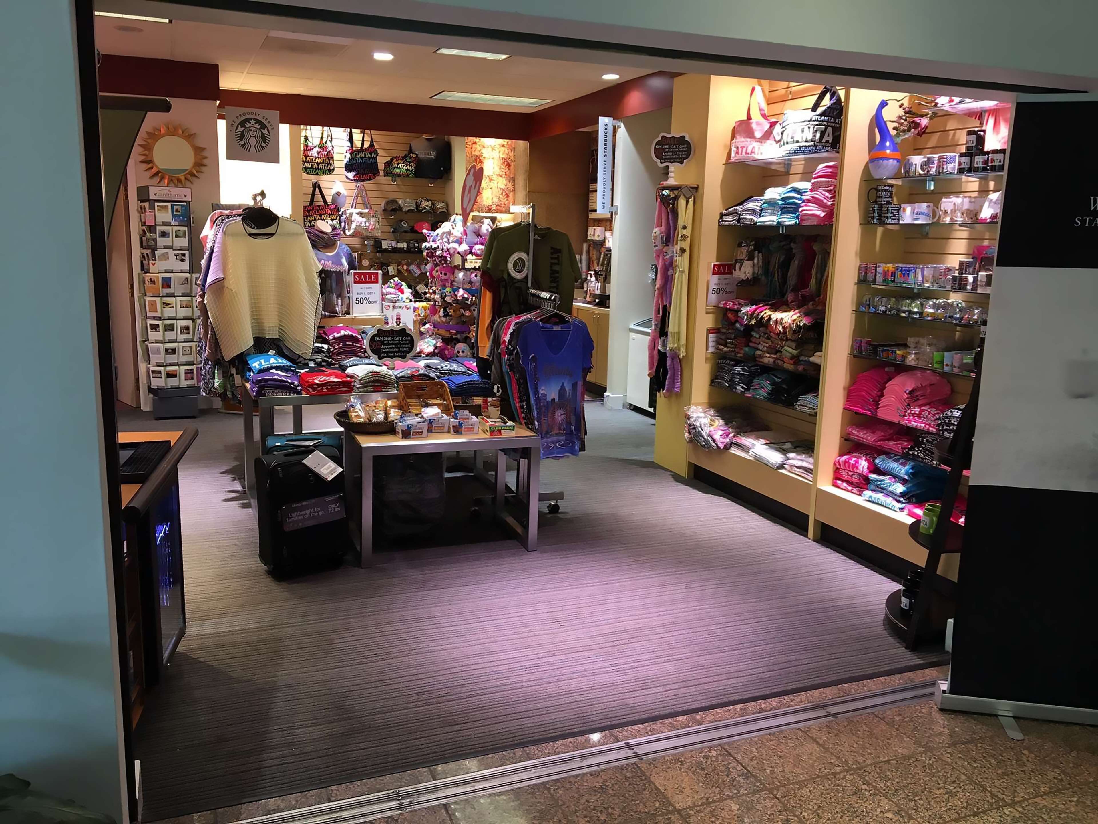A retail store with various merchandise including clothing, bags, and accessories.