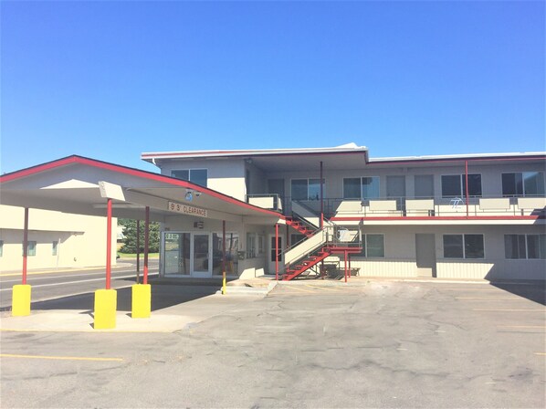 A building with a gas station, a 9'3" clearance sign, and a staircase leading to an upper level. - Teton Lofts (Idaho Falls)