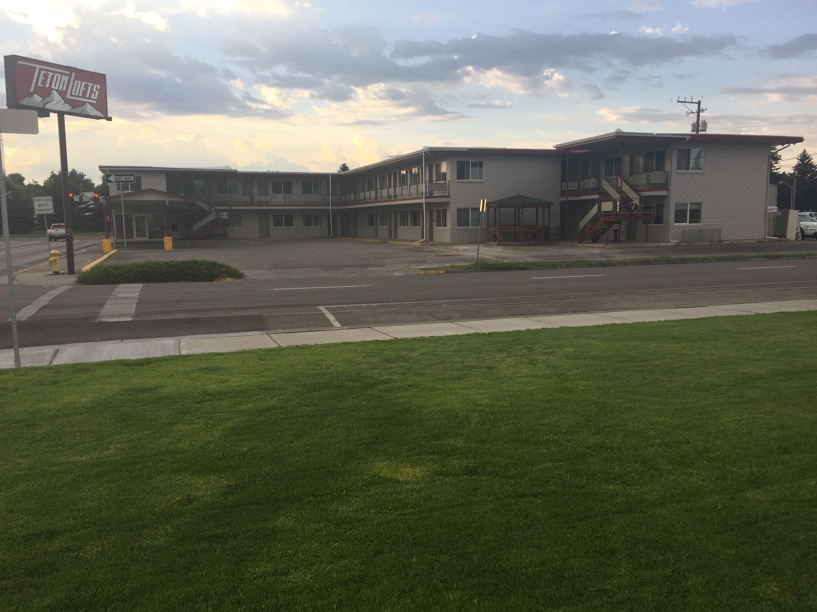 A two-story building with a flat roof and a sign that reads "Teton Lofts".