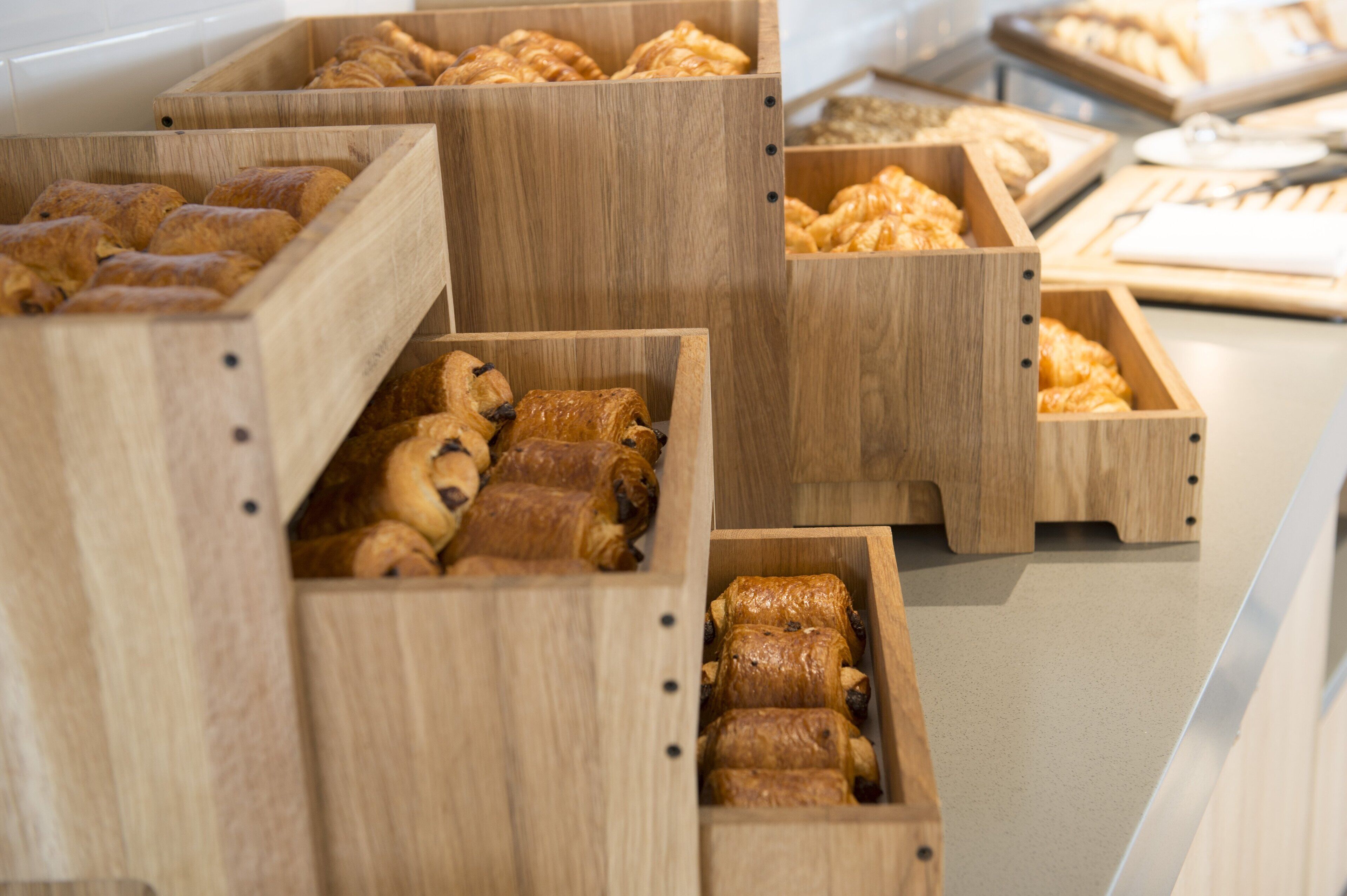 Wooden display cases with pastries.