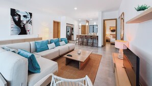 A modern living room with a sofa, coffee table, and a dining area with bar stools. - Choisy Les Bains with LOV (Mont Choisy)
