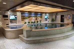 A swimming pool area with a mural, a reception desk, and a tiled floor. - Fuzhou Boerya Wuyi Hotel (Fuzhou)