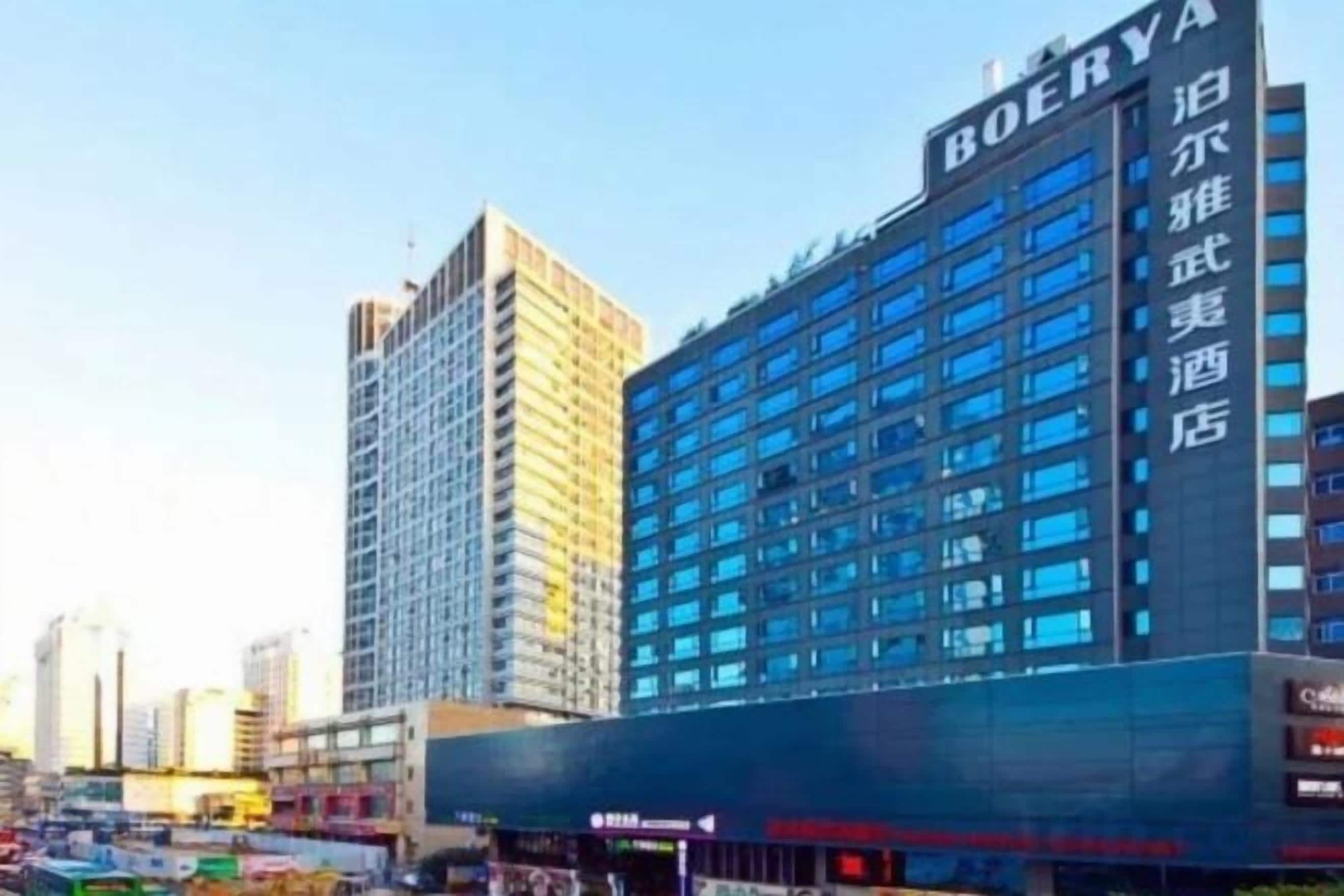 Un hotel de varios pisos con un letrero llamativo, grandes ventanales y un diseño arquitectónico moderno.