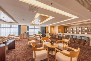 A hotel lobby with a bar area, seating arrangements, and a reception desk. - Novlion Hotel (Shijiazhuang)