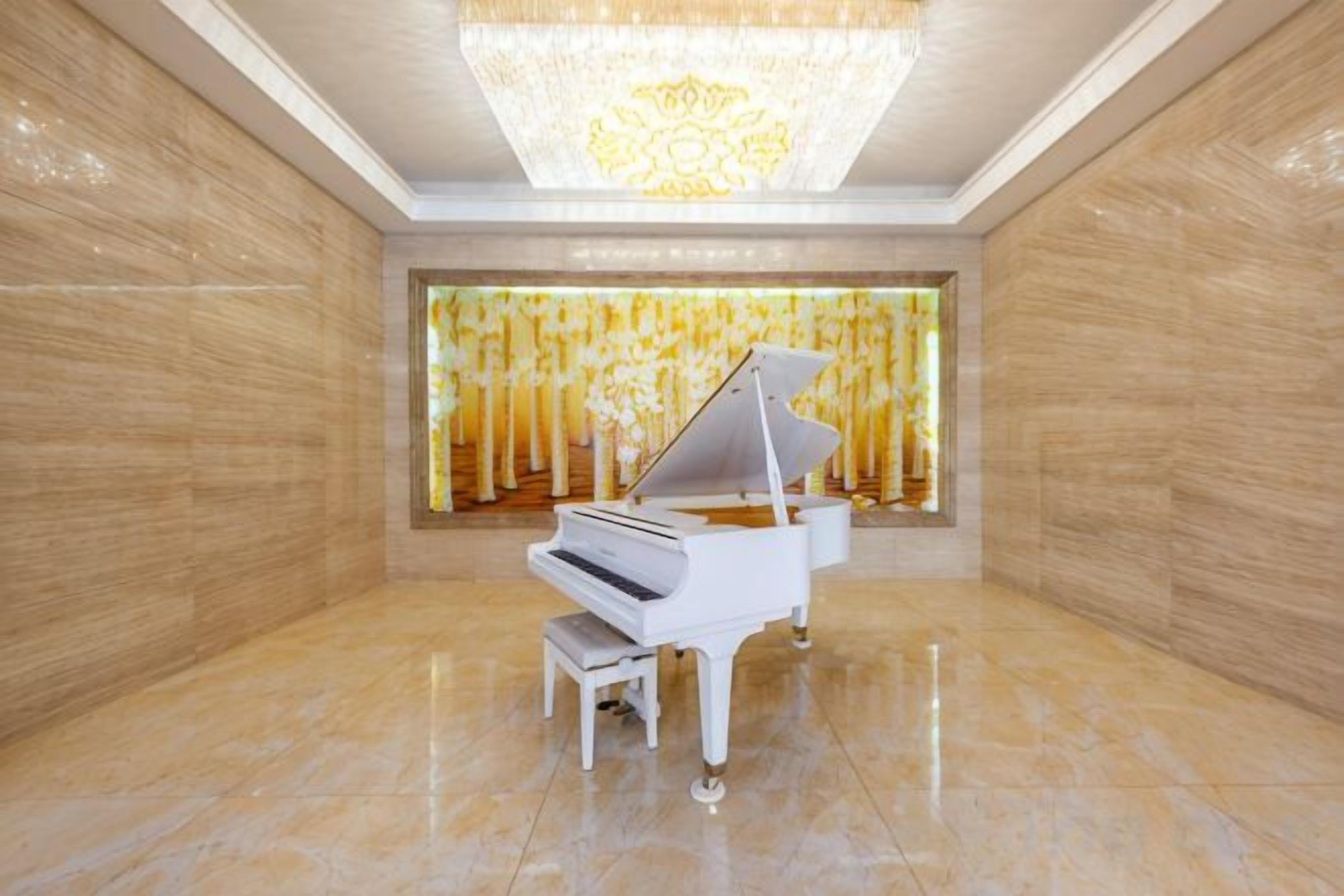 A grand piano in a spacious room with polished marble floors and a large, ornate chandelier.
