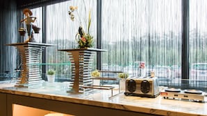 A kitchen counter with a coffee maker, a toaster, and a decorative plant. - Jinjiang Inn (Beijing)
