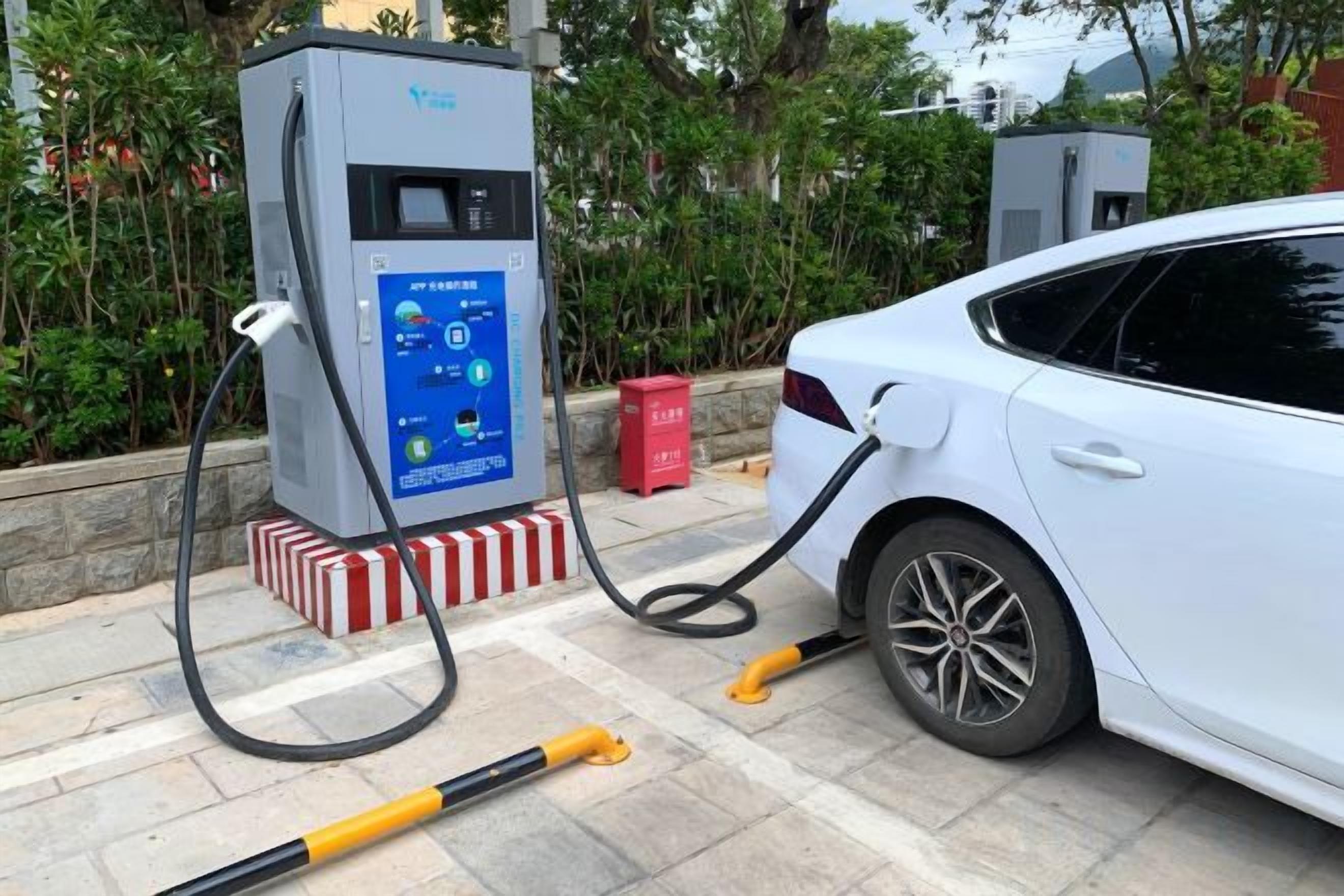 A car charging at a public electric vehicle charging station.